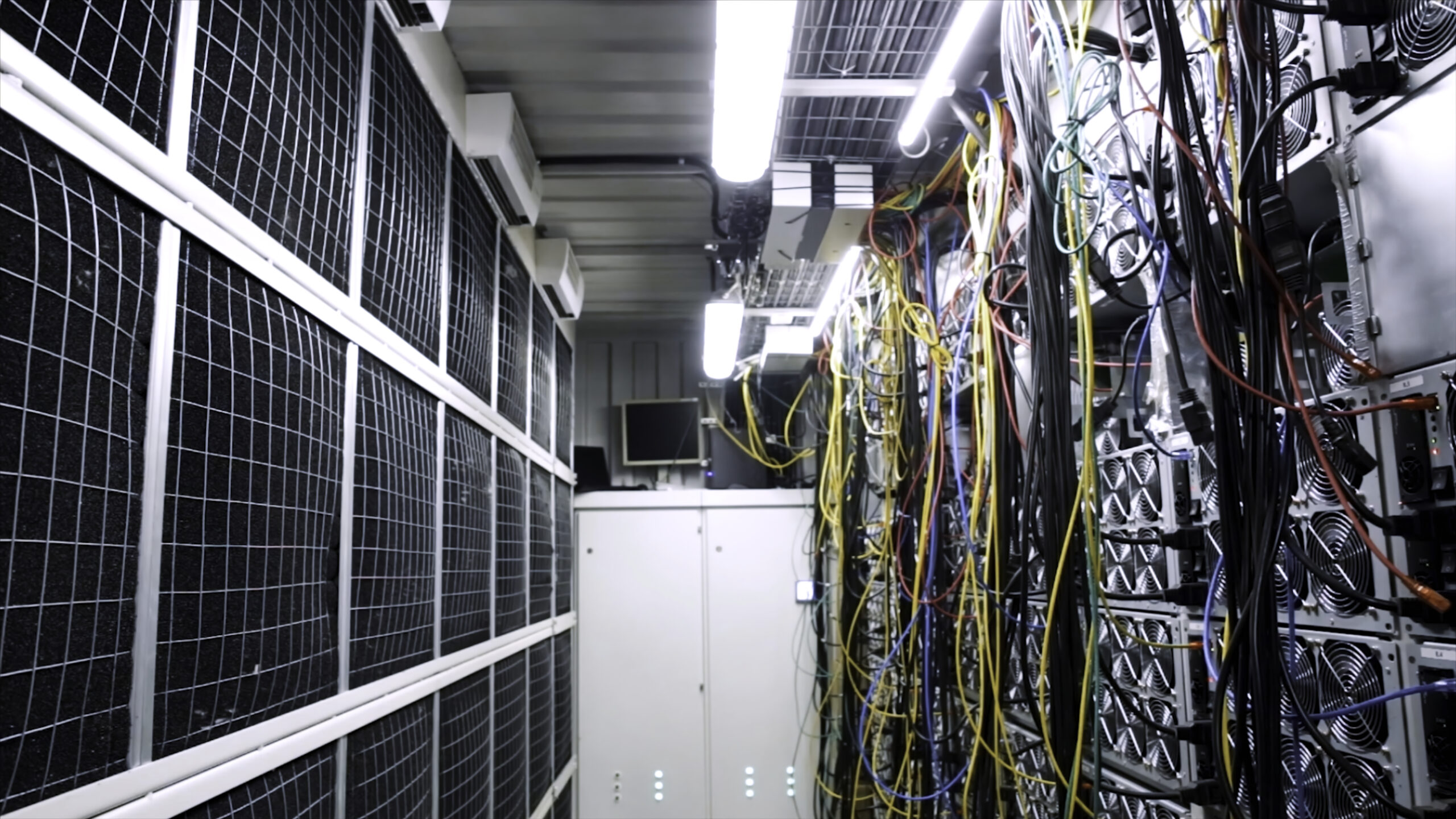Inside room with data centers and cables. Stock footage. Room with data centers, cables and solar panels to absorb bright artificial lighting